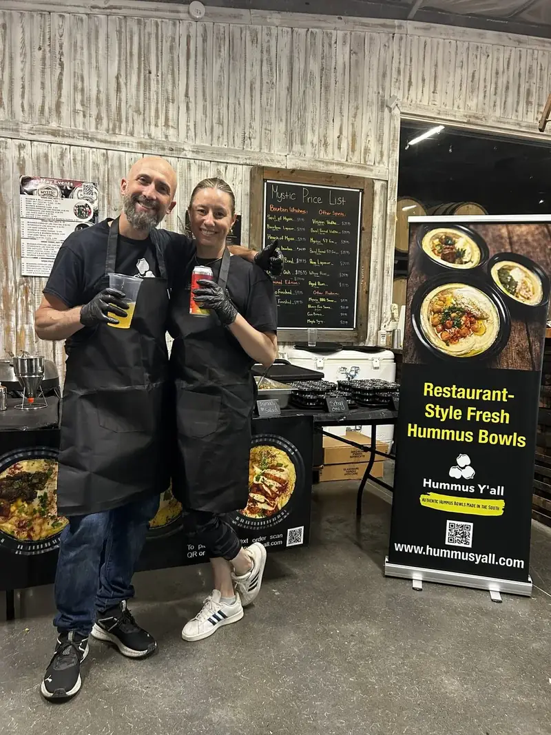 Alon and a teammate at a hummus station event