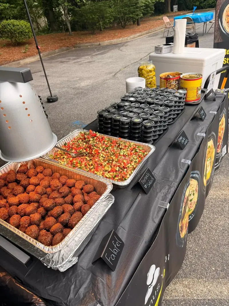 Catering spread with falafel and Israeli salad