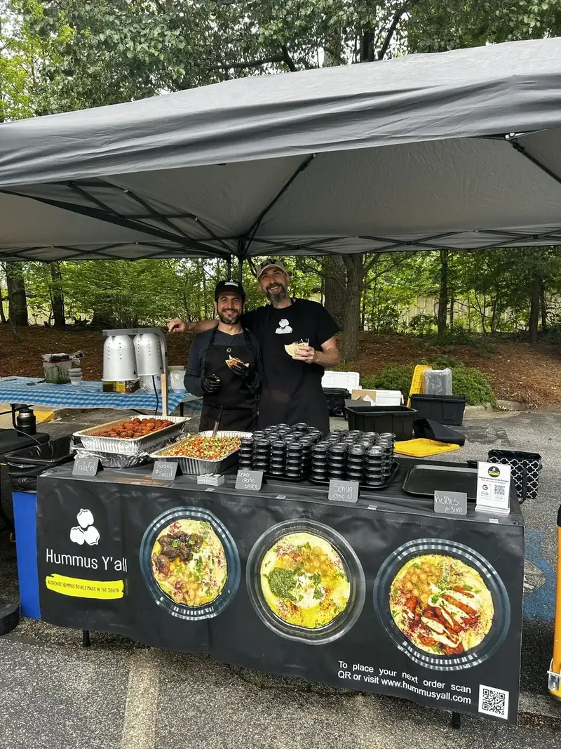 The Hummus Y'all team serving at an outdoor event